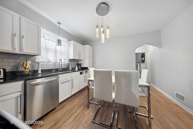 5443 S Long Ave, Chicago, IL 60638 - kitchen with dishwasher, dark countertops, tasteful backsplash, and white cabinets