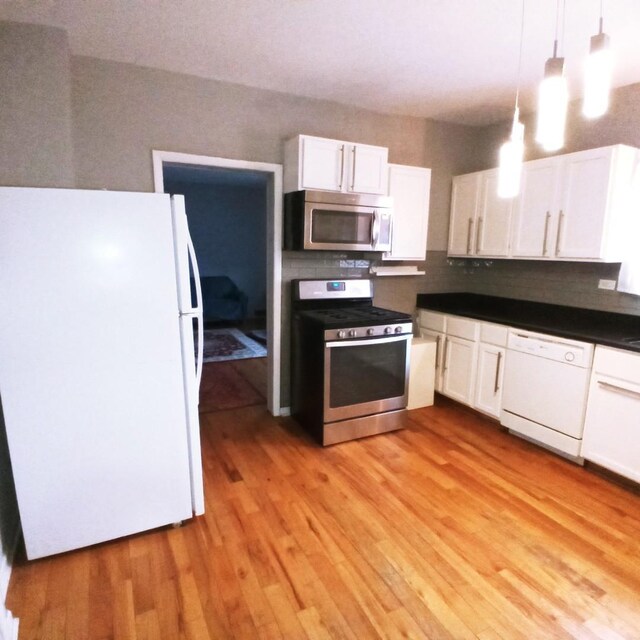 5443 S Long Ave, Chicago, IL 60638 - kitchen featuring stainless steel appliances, white cabinets, decorative backsplash, and light wood-type flooring
