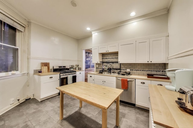 5502 S Hyde Park Blvd Unit 2, Chicago, IL 60637 - kitchen featuring appliances with stainless steel finishes, ornamental molding, white cabinets, tasteful backsplash, and butcher block counters