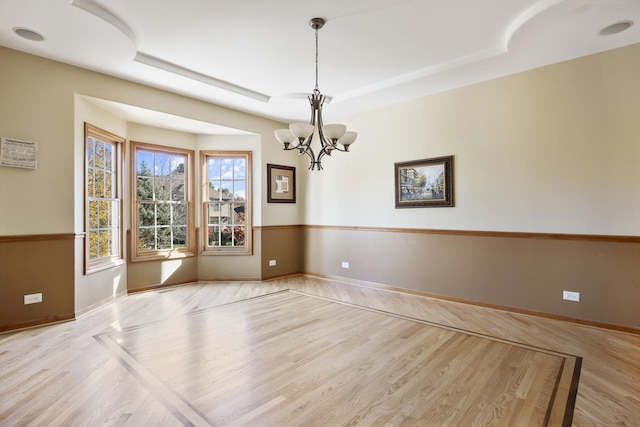 3412 Sunnyside Ct, Naperville, IL 60564 - empty room with a chandelier, wood finished floors, and a raised ceiling