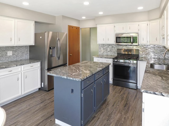 1637 Old Field Ct, Rockton, IL 61072 - kitchen with appliances with stainless steel finishes, blue cabinetry, dark wood-type flooring, white cabinets, and recessed lighting