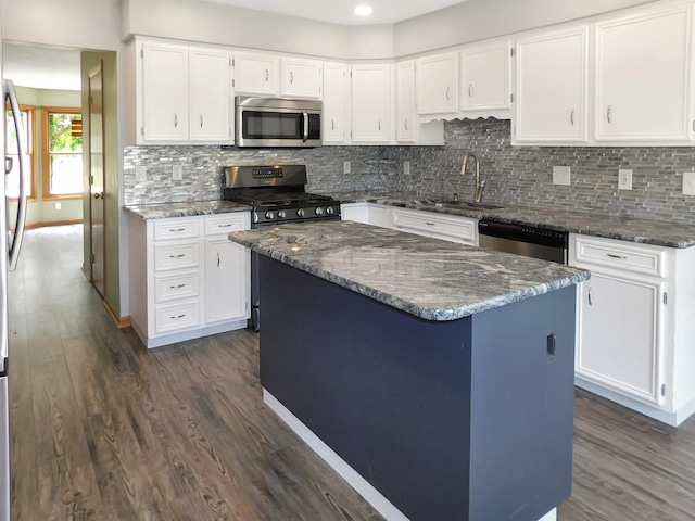 1637 Old Field Ct, Rockton, IL 61072 - kitchen with appliances with stainless steel finishes, dark wood finished floors, dark stone countertops, white cabinets, and decorative backsplash