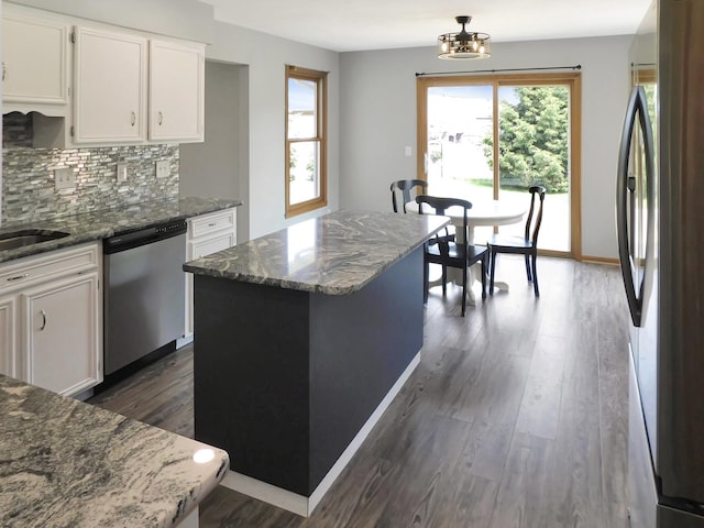 1637 Old Field Ct, Rockton, IL 61072 - kitchen featuring stainless steel appliances, white cabinets, dark wood-type flooring, tasteful backsplash, and dark stone countertops