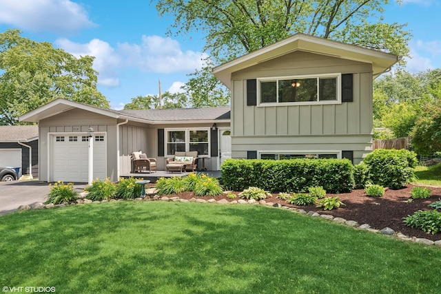 214 S 18th St, Saint Charles, IL 60174 - tri-level home with board and batten siding, a garage, driveway, and outdoor lounge area