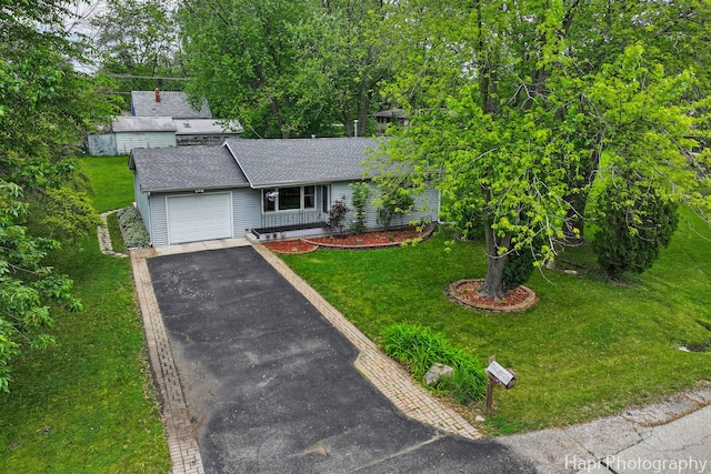 12112 W Bonnie Brook Ln, Beach Park, IL 60087 - view of front of home featuring a garage, asphalt driveway, a shingled roof, and a front lawn