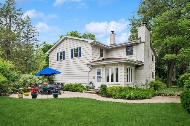 2810 Beckwith Ct, Northbrook, IL 60062 - rear view of property featuring a chimney, a lawn, and a patio