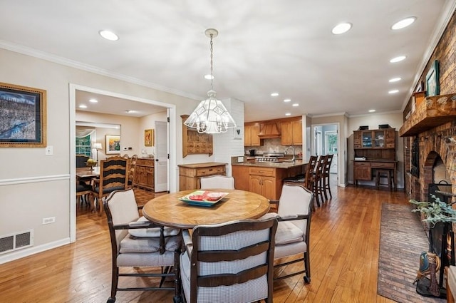 2810 Beckwith Ct, Northbrook, IL 60062 - dining space with hardwood / wood-style floors, recessed lighting, crown molding, a chandelier, and a fireplace