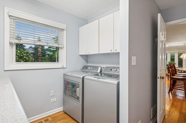 2810 Beckwith Ct, Northbrook, IL 60062 - laundry room with cabinet space, washer and dryer, and light wood-type flooring