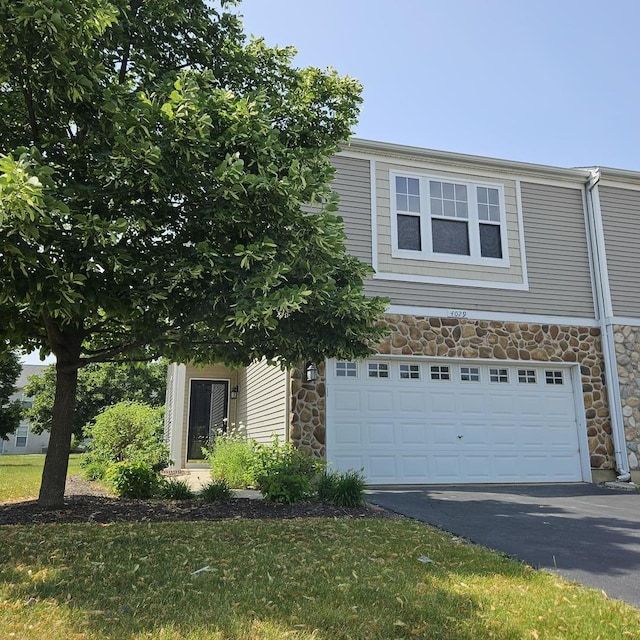 4029 Boulder Ct, Aurora, IL 60504 - view of front of property featuring stone siding, driveway, and a garage