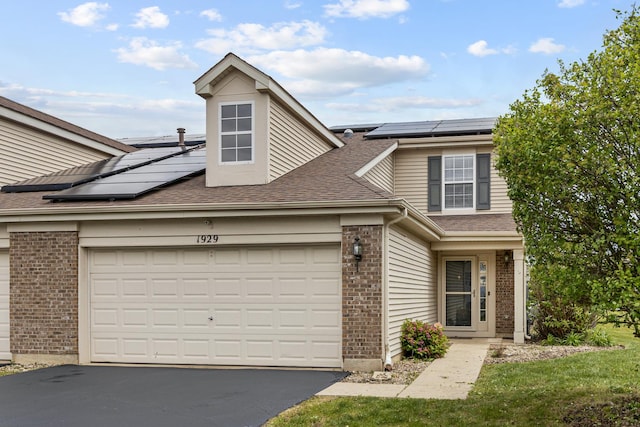 1929 Diamond Head Trl, Pingree Grove, IL 60140 - view of front of property featuring roof mounted solar panels, brick siding, and asphalt driveway