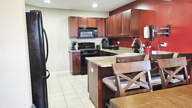 1929 Diamond Head Trl, Pingree Grove, IL 60140 - kitchen with black appliances, light countertops, a peninsula, light tile patterned floors, and a breakfast bar