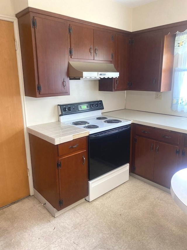 1415 Lakewood Dr, Mendota, IL 61342 - kitchen featuring electric range, under cabinet range hood, and light floors