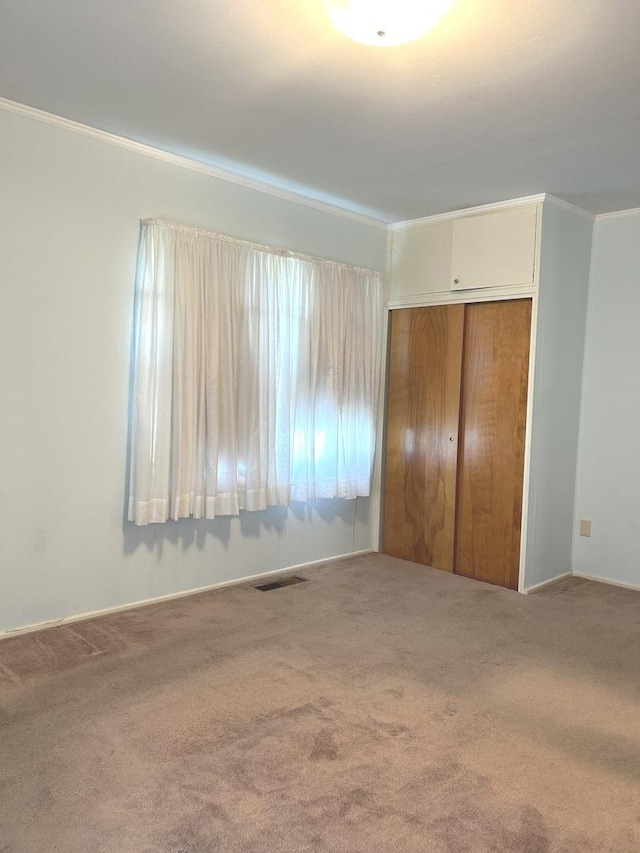 1415 Lakewood Dr, Mendota, IL 61342 - unfurnished bedroom with carpet floors, a closet, and ornamental molding