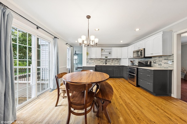 220 E Elm St, Wheaton, IL 60189 - dining area featuring light wood-style floors, a chandelier, crown molding, and recessed lighting