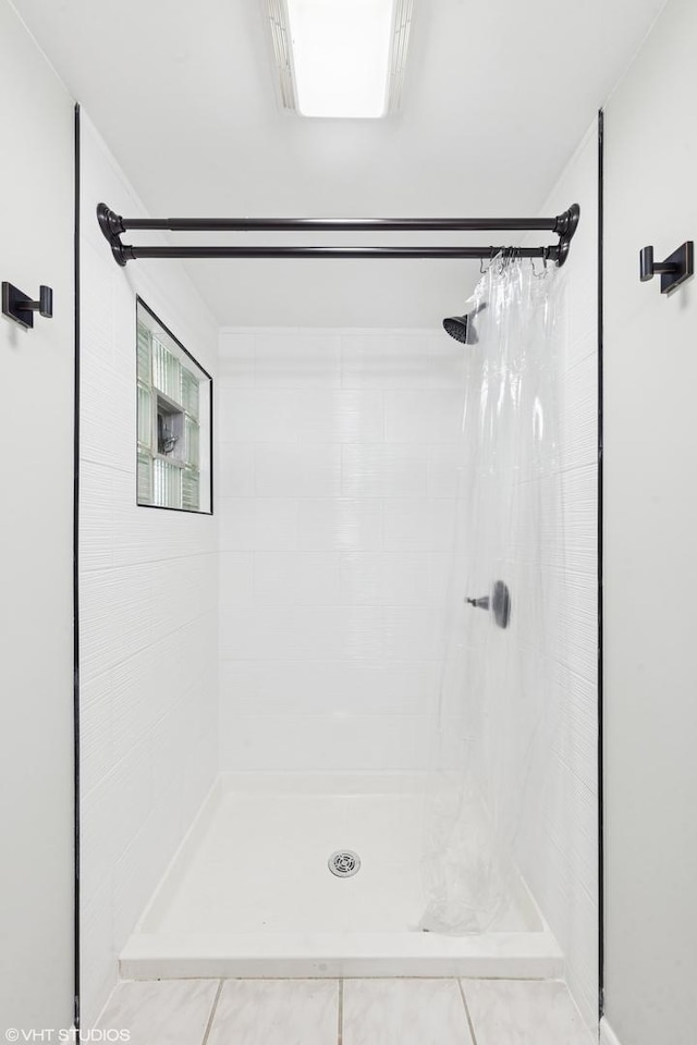 220 E Elm St, Wheaton, IL 60189 - bathroom featuring a tile shower and tile patterned floors