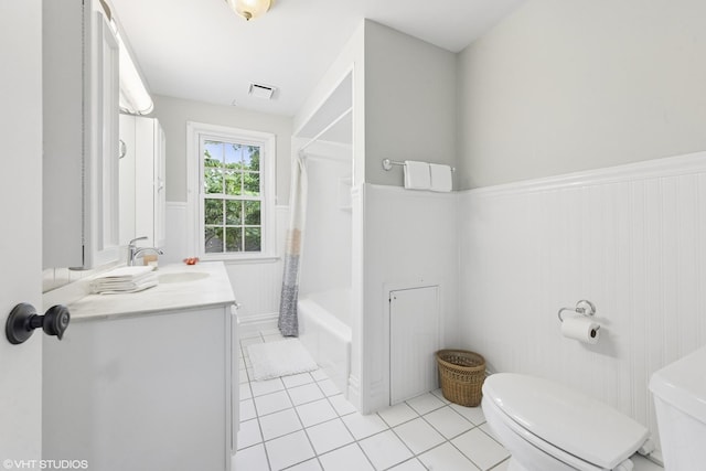 220 E Elm St, Wheaton, IL 60189 - full bath featuring a wainscoted wall, tile patterned flooring, vanity, and shower / bath combo
