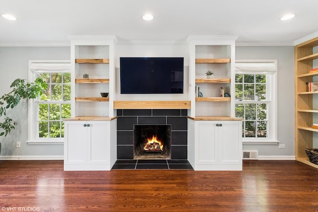 220 E Elm St, Wheaton, IL 60189 - unfurnished living room featuring dark wood-style flooring, a tiled fireplace, recessed lighting, and ornamental molding