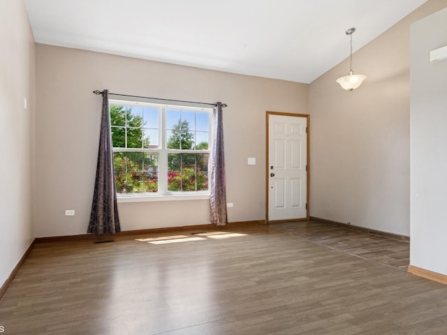 722 Eberly Ct, Plano, IL 60545 - unfurnished room featuring wood finished floors and lofted ceiling