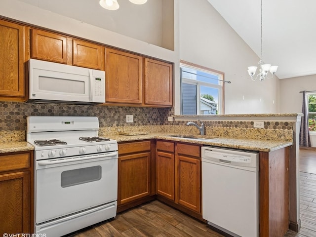 722 Eberly Ct, Plano, IL 60545 - kitchen featuring white appliances, dark wood-type flooring, a peninsula, brown cabinetry, and decorative backsplash