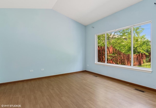 722 Eberly Ct, Plano, IL 60545 - spare room with lofted ceiling and wood finished floors
