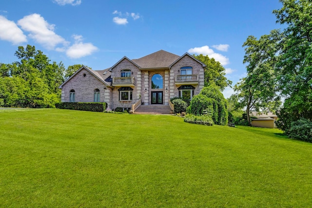 1383 Gordon Ln, Lemont, IL 60439 - french country home featuring a front yard, french doors, stone siding, and a balcony