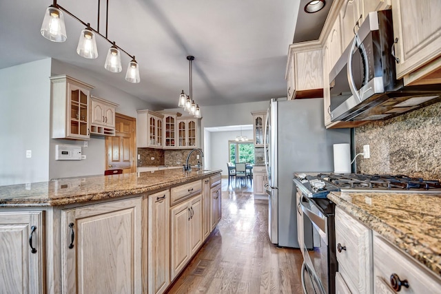 1383 Gordon Ln, Lemont, IL 60439 - kitchen featuring appliances with stainless steel finishes, decorative backsplash, an island with sink, glass insert cabinets, and light wood finished floors