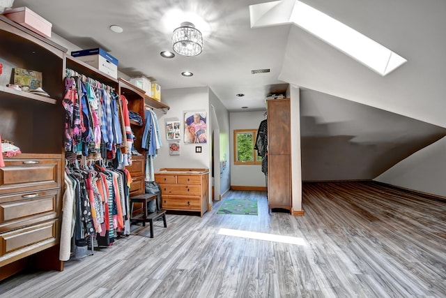 1383 Gordon Ln, Lemont, IL 60439 - walk in closet with a skylight, light wood-style floors, and a chandelier