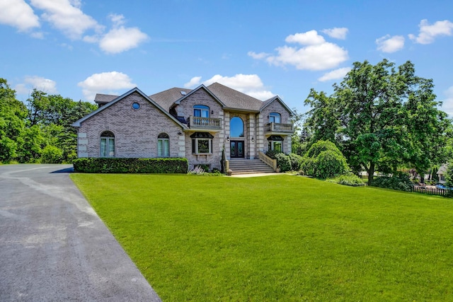 1383 Gordon Ln, Lemont, IL 60439 - french country home with a front lawn, stone siding, brick siding, and a balcony