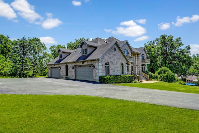 1383 Gordon Ln, Lemont, IL 60439 - view of home's exterior featuring a balcony, driveway, a lawn, a garage, and brick siding