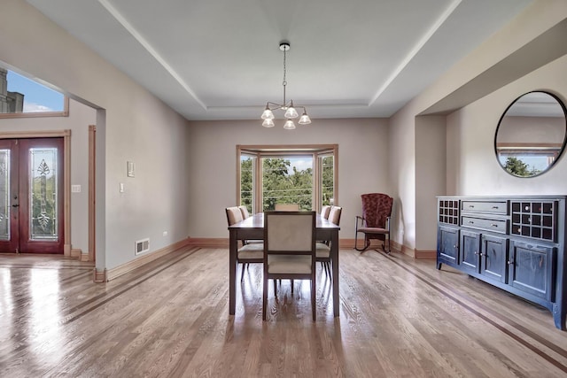 1383 Gordon Ln, Lemont, IL 60439 - dining area featuring a tray ceiling, light wood finished floors, and a chandelier