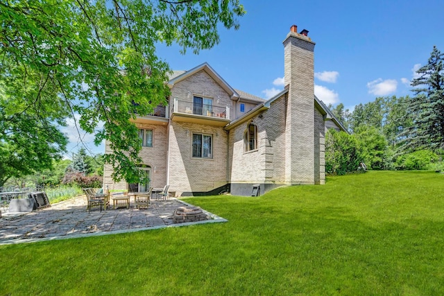 1383 Gordon Ln, Lemont, IL 60439 - back of house with a balcony, a patio, a yard, a chimney, and brick siding