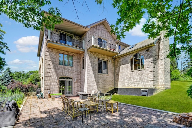 1383 Gordon Ln, Lemont, IL 60439 - back of property with a lawn, brick siding, a patio area, and a balcony