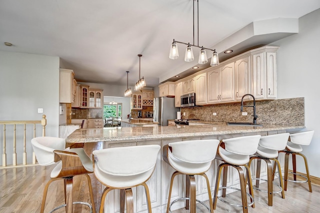 1383 Gordon Ln, Lemont, IL 60439 - kitchen with appliances with stainless steel finishes, a peninsula, glass insert cabinets, tasteful backsplash, and light wood-type flooring