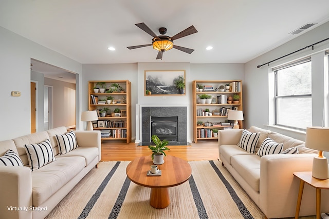 6829 N Lakewood Ave Unit 3, Chicago, IL 60626 - living area featuring a tile fireplace, ceiling fan, wood finished floors, and recessed lighting
