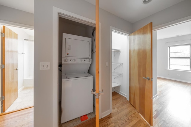 6829 N Lakewood Ave Unit 3, Chicago, IL 60626 - washroom with stacked washer / dryer and light wood-style flooring