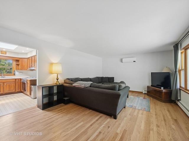 3004 Blarneystone Ln, Cary, IL 60013 - living room with light wood-style floors, a wall mounted AC, a baseboard radiator, and a baseboard heating unit