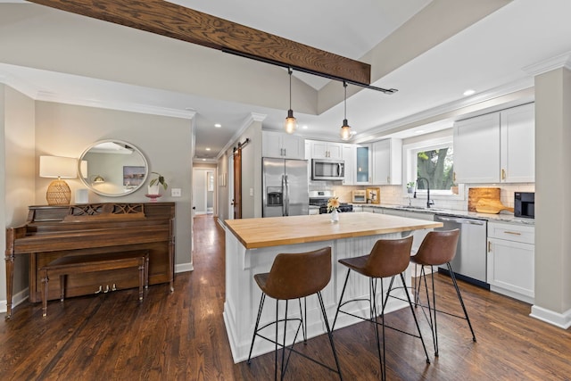 26W079 Thomas Rd, Wheaton, IL 60187 - kitchen featuring appliances with stainless steel finishes, butcher block countertops, ornamental molding, a center island, and a breakfast bar