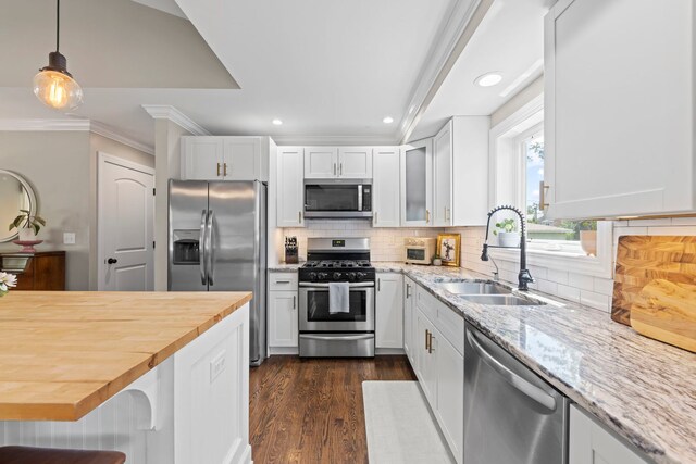 26W079 Thomas Rd, Wheaton, IL 60187 - kitchen with appliances with stainless steel finishes, butcher block counters, recessed lighting, white cabinetry, and backsplash
