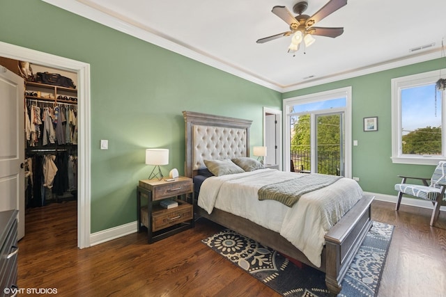 3252 N California Ave Unit 2, Chicago, IL 60618 - bedroom with a walk in closet, crown molding, dark wood-style flooring, a closet, and ceiling fan