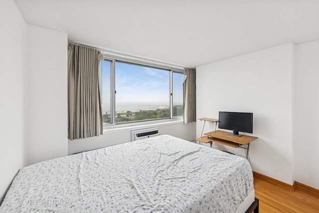 2144 N Lincoln Park W Unit 23B, Chicago, IL 60614 - bedroom featuring wood finished floors and a wall mounted air conditioner