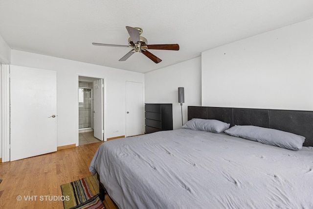 2144 N Lincoln Park W Unit 23B, Chicago, IL 60614 - bedroom with wood finished floors, a ceiling fan, and ensuite bath