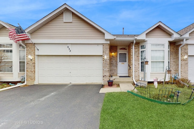 832 Veridian Way Unit 832, Cary, IL 60013 - view of front facade with brick siding, driveway, a garage, a front yard, and roof with shingles