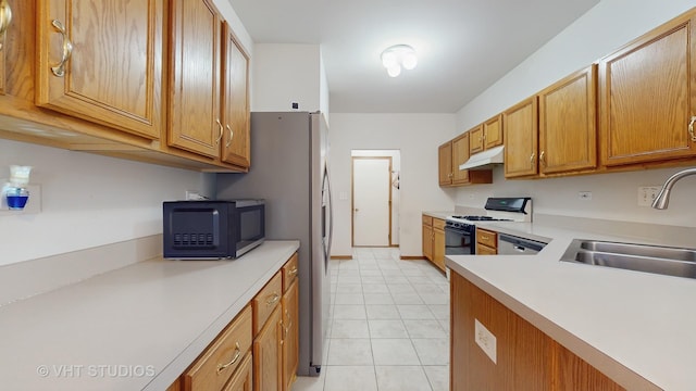 832 Veridian Way Unit 832, Cary, IL 60013 - kitchen featuring white gas range oven, under cabinet range hood, black microwave, light countertops, and light tile patterned flooring
