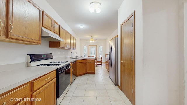 832 Veridian Way Unit 832, Cary, IL 60013 - kitchen featuring under cabinet range hood, stainless steel appliances, a peninsula, light countertops, and light tile patterned flooring