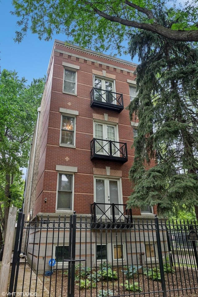 1048 W Lill Ave Unit 2, Chicago, IL 60614 - multi unit property with brick siding, a balcony, and a fenced front yard