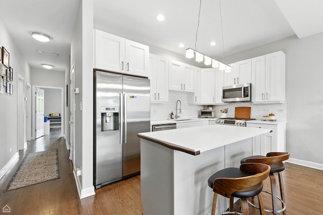 2736 N Wolcott Ave Unit 101, Chicago, IL 60614 - kitchen featuring stainless steel appliances, dark wood-style flooring, tasteful backsplash, and recessed lighting