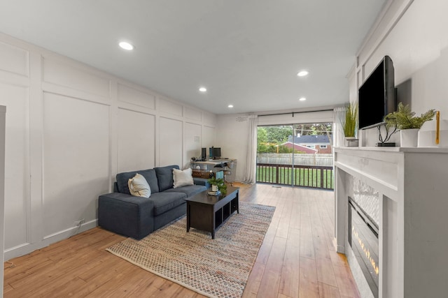 523 Kipling Ct, Wheaton, IL 60187 - living room with a decorative wall, a glass covered fireplace, light wood-style floors, and recessed lighting