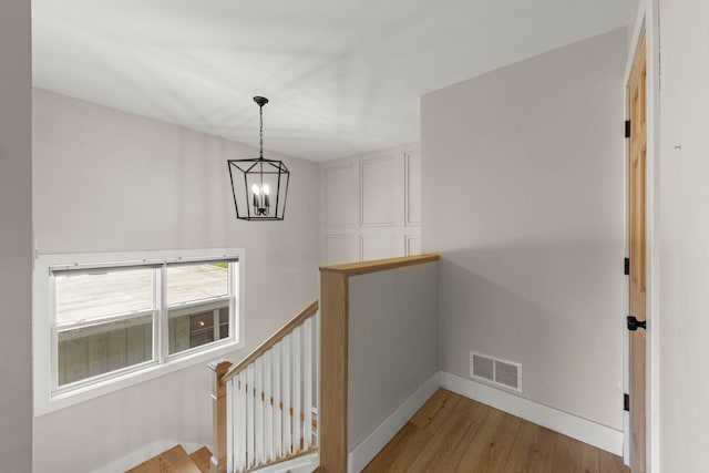 523 Kipling Ct, Wheaton, IL 60187 - hall featuring an upstairs landing, a chandelier, and wood finished floors