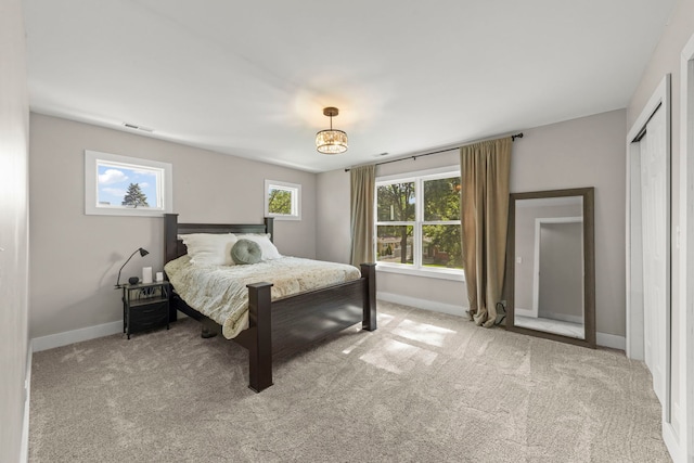 523 Kipling Ct, Wheaton, IL 60187 - bedroom featuring light carpet and a chandelier