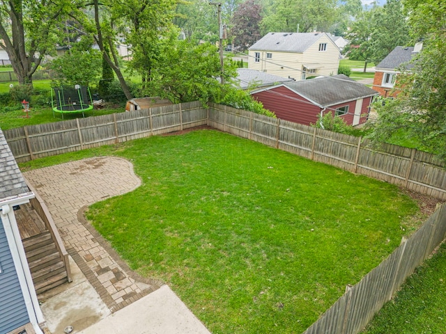 523 Kipling Ct, Wheaton, IL 60187 - fenced backyard featuring a trampoline and a patio area